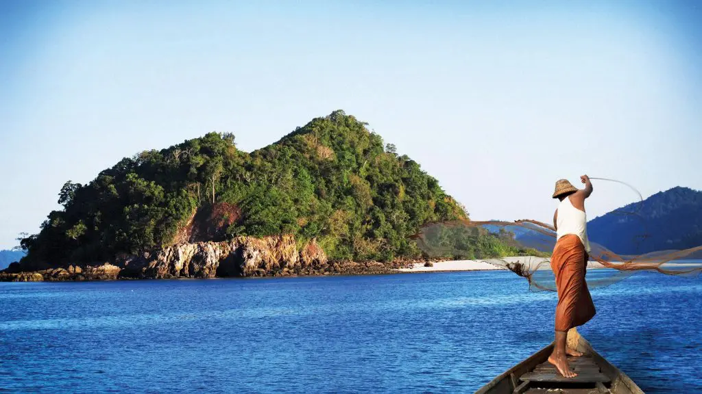 Local Burmese fisherman clam fishing off the coast of Wa Ale